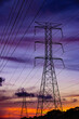 © Andrei Liashchou - High voltage power lines and transmission towers silhouetted against a dramatic sunset sky.