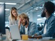 © Business Pics - Multiracial colleagues supporting an overwhelmed coworker in open office space