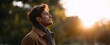 © ckybe - Caucasian dude relaxing and soaking up morning vibes in a park at sunrise