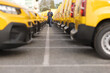 © Ljupco Smokovski - Mechanic walking through a fleet of yellow vans