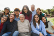 © DisobeyArt - Group of multigenerational people smiling in front of camera - Multiracial friends with different ages having fun together - Main focus on caucasian senior face