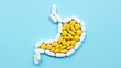 © olga_demina - A creative visual representation of stomach pain and medication, featuring a stomach shape formed by pills and capsules on a light blue background.