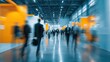 © Danil - Blurred motion of business people walking in a convention center hallway.