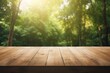 © nsit0108 - Empty wooden table with blurred green forest and soft sun flare providing a nature background
