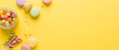 © CleanSpace Studio - Colorful sweets background with french macarons lollipops and fruit candies on yellow surface with copy space for birthday or holiday celebration concept