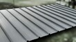 © Kitta Studio - Close-up of a modern grey corrugated metal roof with a blurred background, architectural detail