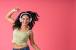 © Guillermo Spelucin - Young woman enjoying music, dancing with happiness