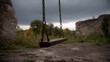 © photo for everything - Rusty old swing seat with heavy chains in a derelict, overcast outdoor setting, evoking feelings of abandonment and melancholy