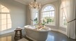 © Andres Mejia - Luxurious Freestanding Bathtub in an Elegant Bathroom with Chandelier, Champagne, and Natural Light