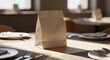 © ramenguy - Brown paper lunch bag on a table set for a meal, sunlight casting shadows, ready for takeaway or delivery service
