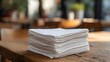 © decorator - Clean white napkins neatly stacked on a rustic café table evoke simple hospitality moments
