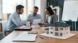© Keo - A man and a woman are intently reviewing a purchase agreement and mortgage application with a third man.