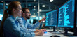 © Viktor - Two software engineers collaborate at office desks, analyzing code on multiple computer monitors. Teamwork in tech industry, men, women programmers working on project. Data analysis, digital