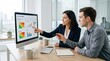 © velikiyzayats - Professional female and male consultants analyzing enterprise risk management dashboard in modern office