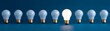 © Yuparet - leadership choosing direction in uncertainty, Illuminating Bright Idea Among Dim Bulbs on Dark Background with Copy Space