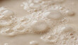 © Екатерина Чумаченко - Macro view of light brown liquid with small and large bubbles, close up