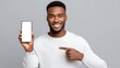 © Iaroslav - Happy black guy holding smartphone with empty white display, showing new service online application