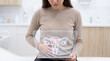 © peacefy - A woman examining digital representation of the female reproductive system.