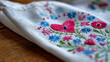 © Nataliya - Close-up of embroidered heart on handmade fabric card, children's craft concept, handmade gift for mom, love and creativity, with copy space