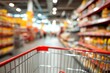 © VICHIZH - Shopping cart in supermarket aisle with blurred shelves and products for grocery shopping and retail consumer goods in store environment.