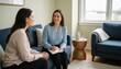 © Breezze - Smiling psychologist with notebook talking to woman on sofa for mental wellness advertising, psychotherapy services and professional consultation campaign