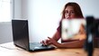 © FranciscoJavier - Woman creating online video content, live streaming on smartphone with laptop