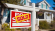 © iconic - A 'For Sale' sign with a 'Sold' overlay indicating a successful real estate transaction for a house.