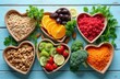 © Pete - Variety of fresh fruits vegetables nuts and grains arranged in heart shapes. Healthy eating for wellbeing and good nutrition. Assorted food items for balanced diet.