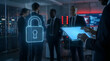 © Frendev - Business team in a technology room with a glowing lock icon in the foreground. Concept of enterprise security, protected systems, and cybersecurity strategy