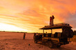 © Marc Romanelli - Family on vacation experiencing sunset over the Nxai Pan, Kalahari Desert, Botswana, Africa