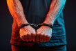 © Alina - Clenched hands in handcuffs