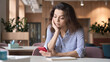 © insta_photos - Indian female student holding smartphone sitting at table in modern creative space office using smartphone learning app. Latin teenager looking in cellphone surfing social media texting messaging.