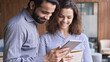 © insta_photos - Smiling indian and latin colleagues talk use digital tablet in office. Male mentor, manager having friendly discussion with female latin coworker collaborate in teamwork work on project together.