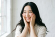 © maaagram - 驚きと喜びの表情で頬に手を当てる日本人女性 美容 スキンケア ライフスタイル Generative AI