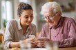 © sogap - Young woman helps elderly man use smartphone, close-up over-the-shoulder view indoors