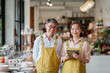 © Jestercine - Father and daughter Asian small business owners standing in their shop