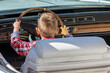 © Florin - Funny image with one little boy at the wheel of an old and vintage car.