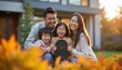 © Vadym - Asian family smiles near mailbox at home on sunny autumn day. Parents and two happy daughters pose outdoors in warm light. Children hold mailbox together.