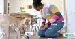 © vectorfusionart - Kneeling woman in sweater leaning toward 2 dogs at kitchen steel bowl, social overlays, copy space