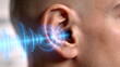 © Magdalena Wojaczek - Close-up of human ear with digital sound waves emanating inwards, illustrating auditory perception