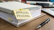 © nabila - Notebook and Sticky Note with Approval Pending on Wooden Desk