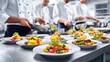 © vectorizer88 - Chefs Assembling Dishes in Long Stainless Steel Prep Area in Kitchen