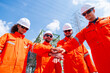 © Washburn - Engineering Team Stacking Hands in Refinery Teamwork Concept