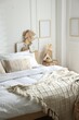 © New Africa - Large bed with clean linens and decor near white wall in bedroom. Interior design
