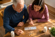 © Natallia Simanchyk - Senior man and woman organize pills into a weekly box. Scene highlights care and health management for the elderly. Useful for healthcare, aging, and family support themes.