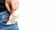 © Nazmul - Close up of a hand placing a note card with 'National Poem in Your Pocket Day' text into a blue denim jeans pocket, isolated on white background with copy space.