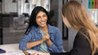 © fizkes - Women colleagues chatting during informal meeting in modern office, laughing, radiating enthusiasm and positivity in workplace during break and casual conversation. Communication, workplace friendship