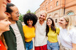 © Xavier Lorenzo - Happy young friends standing together in urban area. Multiracial group enjoying friendship and social connection outdoors. Community and lifestyle concept.