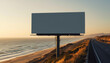 © Muhammad Umar - A prominent blank billboard stands beside a coastal highway overlooking the Pacific Ocean at sunset, ready for your message.