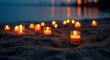 © Fariz - Numerous glowing votive candles illuminate a sandy beach at twilight with blurred city lights